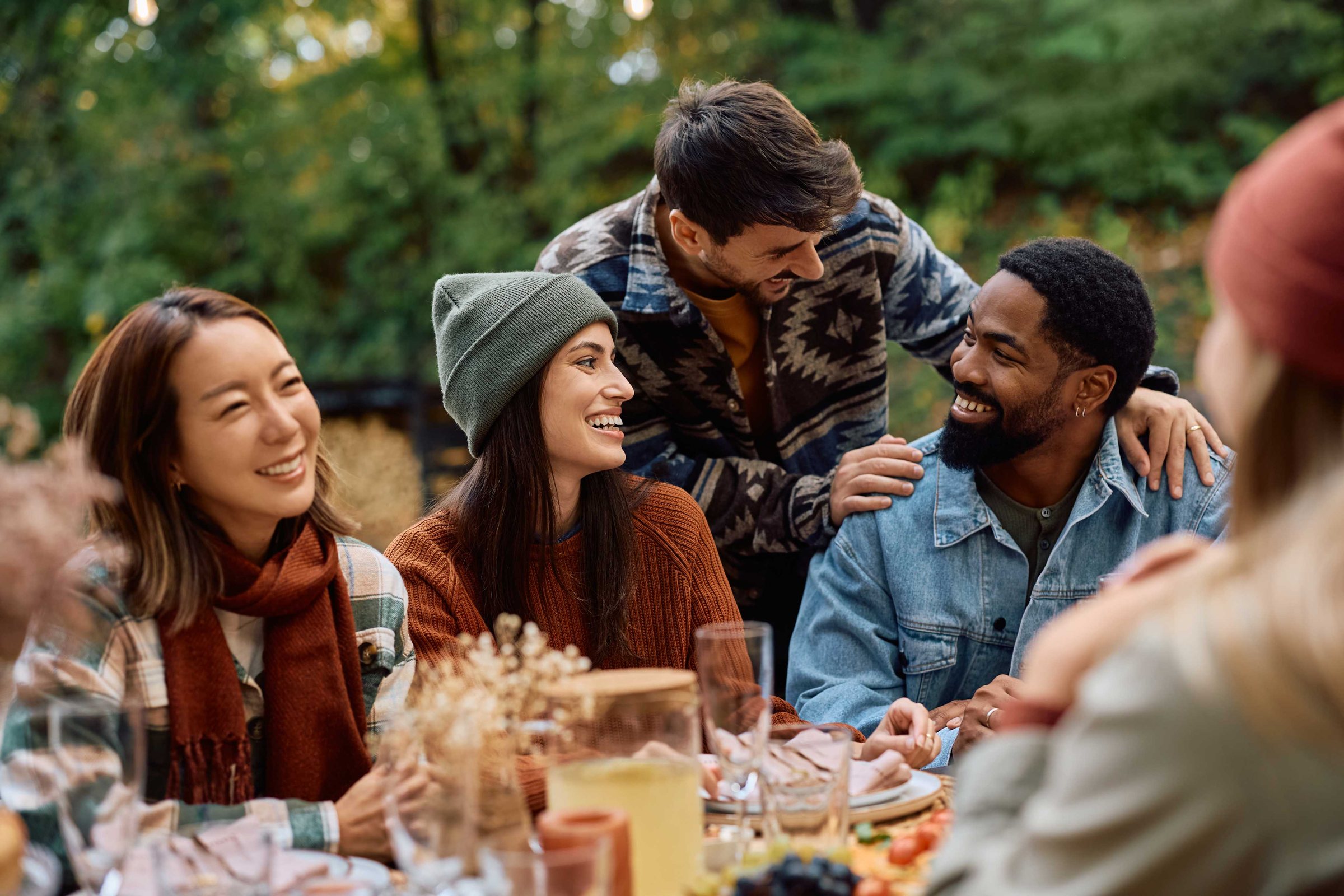 A group of friends sharing a meal and conversation outdoors