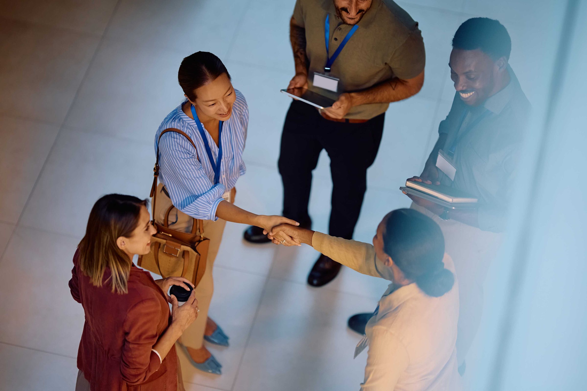 Overhead view of volunteers shaking hands at a donation drive
